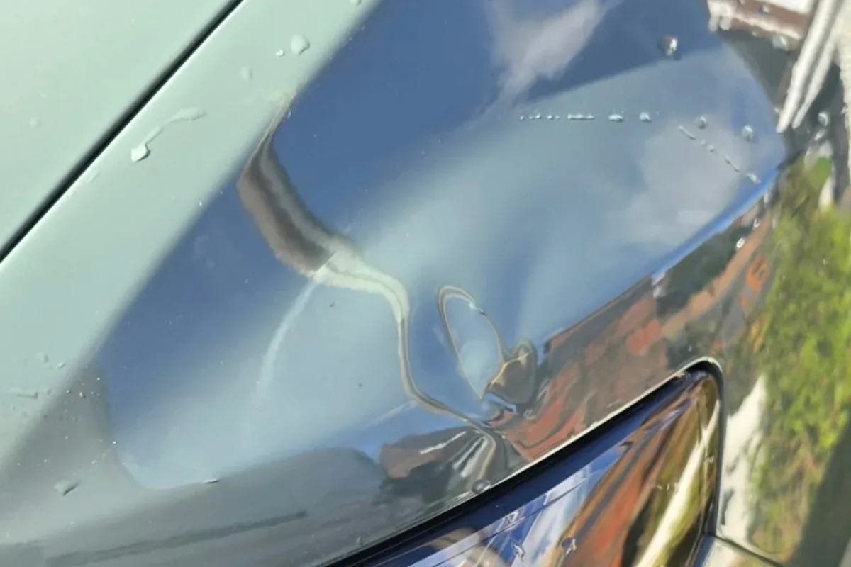 Small dip in the bonnet just above a headlamp